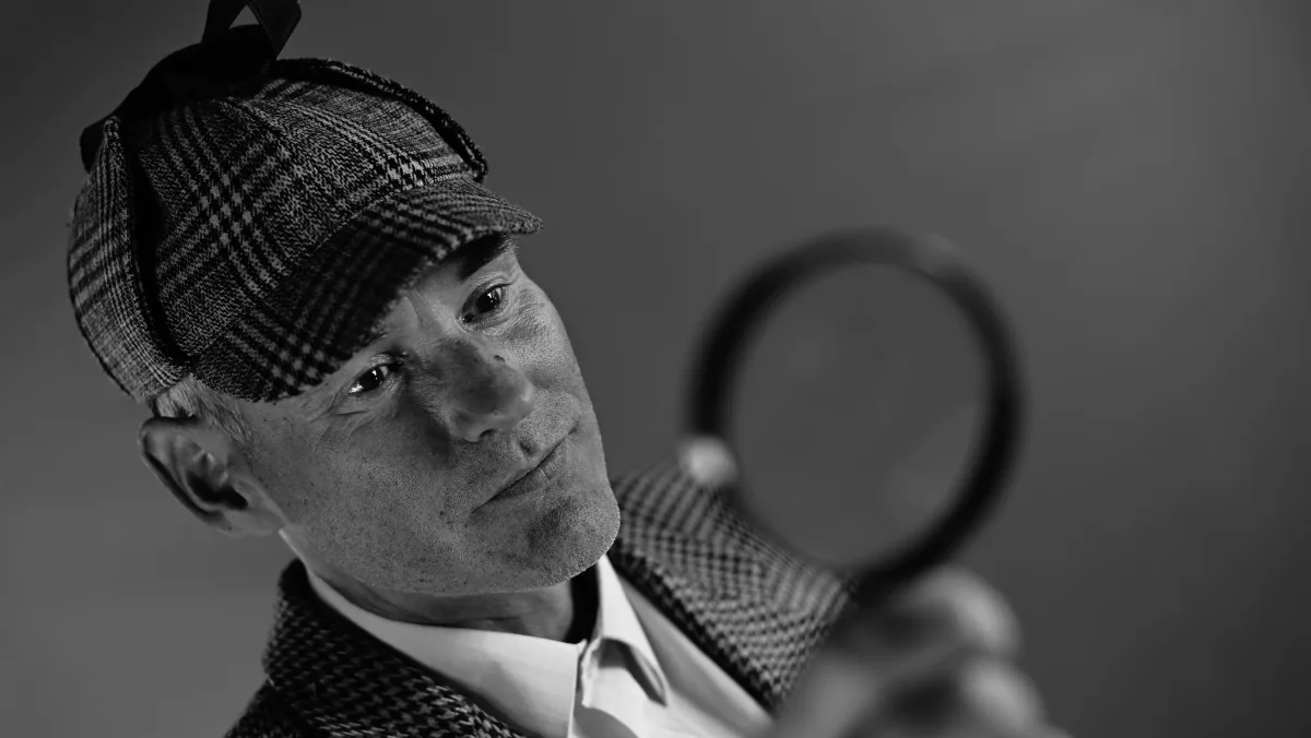 A man looking through a magnifying glass