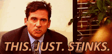 Michael Scott with gum in his hair saying, "This just stinks".