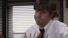 Jim from The Office crossing his fingers.