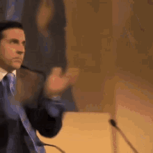Michael Scott spinning, giving finger guns, and then walking off stage.