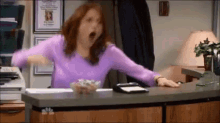 Erin from The Office standing and celebrating