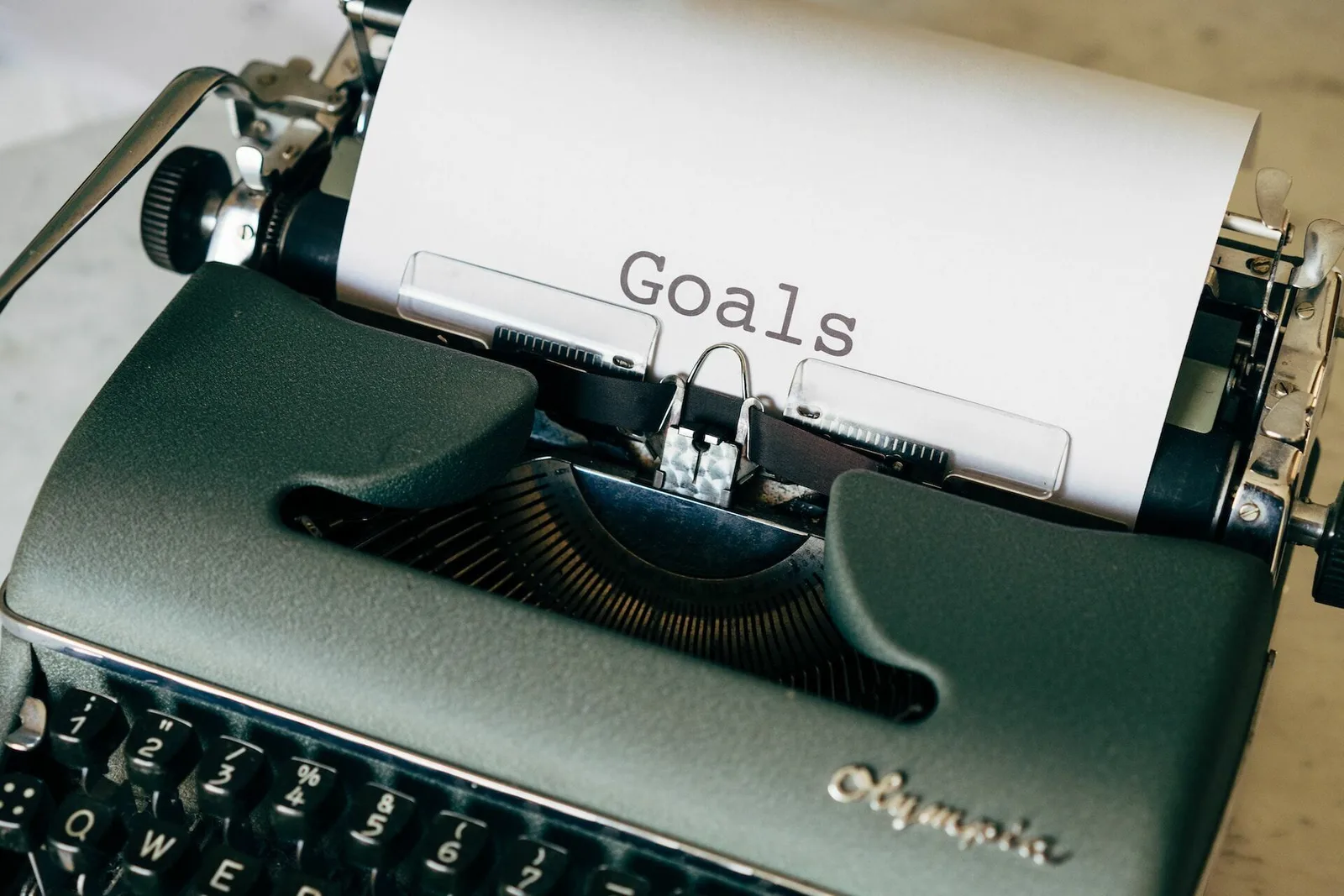 A typewriter with the "goals" printed on a piece of paper sticking out of it