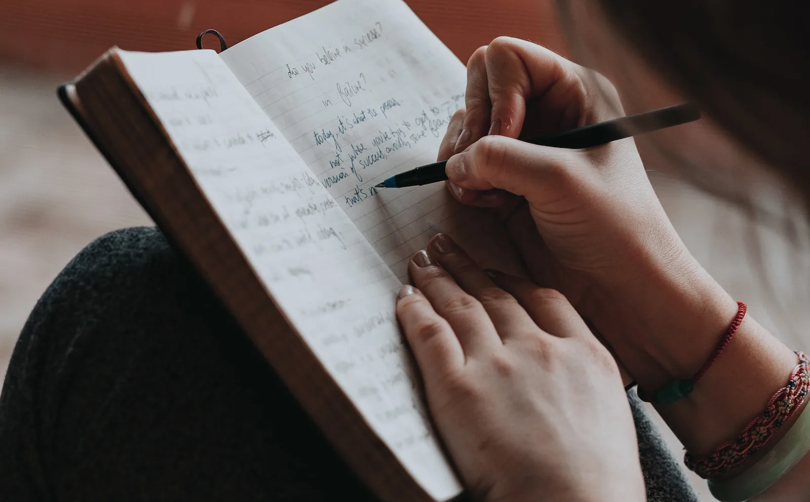 Someone writing notes in a notebook