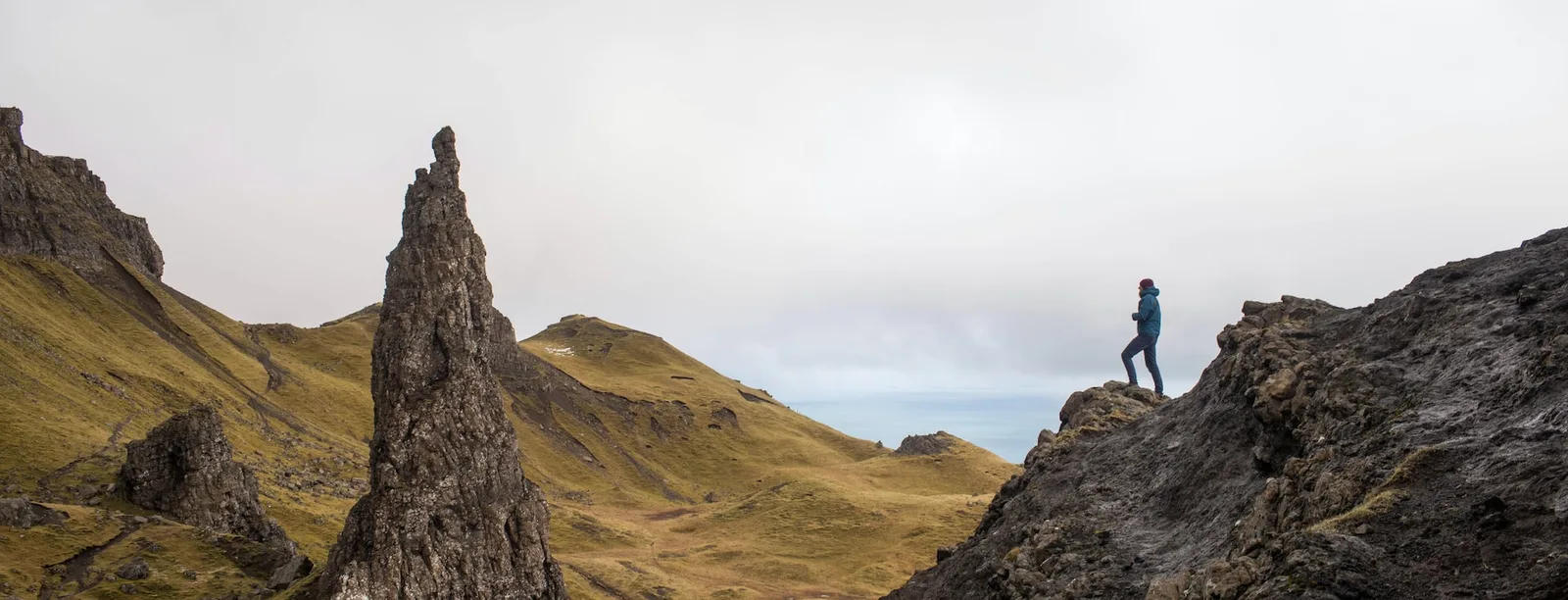 A person standing on a large rock